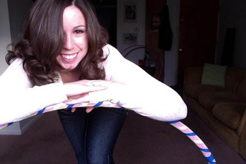 Ashley Miller, a master’s degree graphics student, poses with one of the hula hoops that she has designed and decorated. Miller has sold more than 40 hoops to buyers across the country. PHOTO PROVIDED BY ASHLEY MILLER