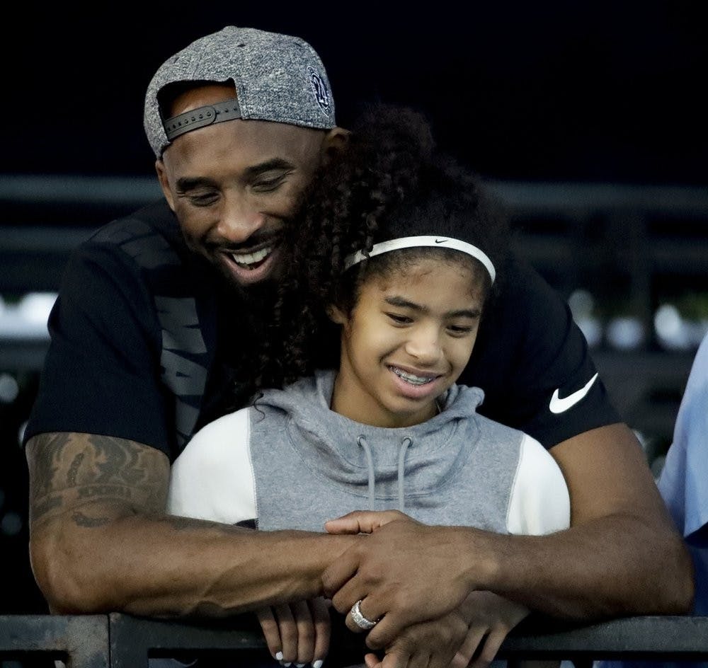 <p>FILE - In this July 26, 2018 file photo former Los Angeles Laker Kobe Bryant and his daughter Gianna watch during the U.S. national championships swimming meet in Irvine, Calif. Bryant, the 18-time NBA All-Star who won five championships and became one of the greatest basketball players of his generation during a 20-year career with the Los Angeles Lakers, died in a helicopter crash Sunday, Jan. 26, 2020. Gianna also died in the crash. She was 13. <strong>(AP Photo/Chris Carlson)</strong></p>