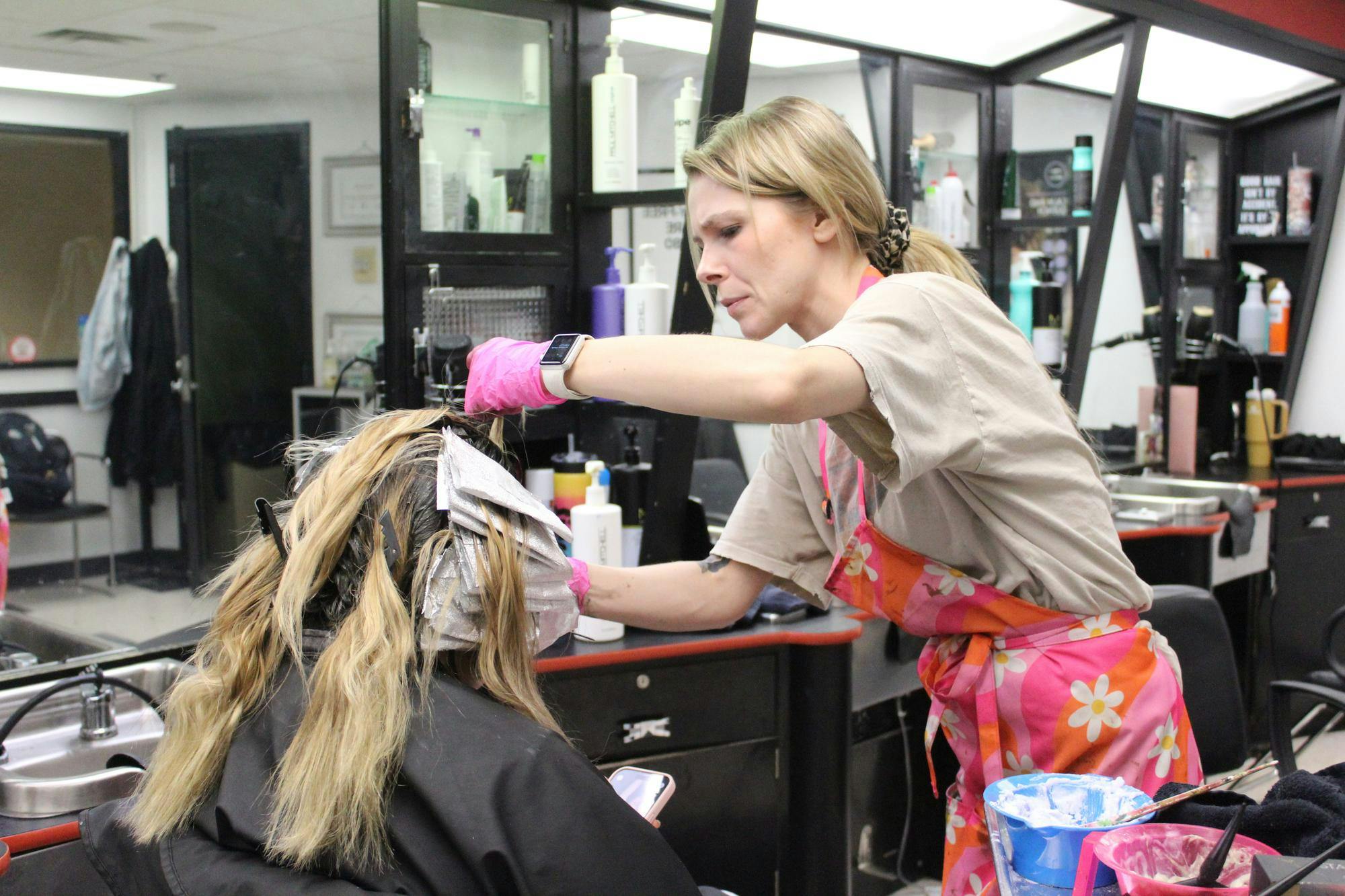 Stylist Sierra West colors a student's hair Feb. 28 at the L.A. Pittenger Student Center. “My parents are Ball State alums, so I’m from Muncie and I love working here,” West said. “I also love talking to the students. They are always so friendly and appreciative of the work we do.” Meghan Braddy, DN