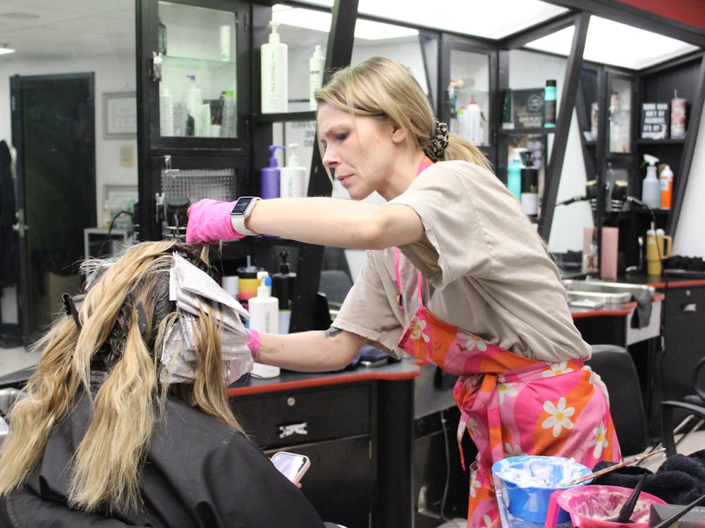 Stylist Sierra West colors a student's hair Feb. 28 at the L.A. Pittenger Student Center. “My parents are Ball State alums, so I’m from Muncie and I love working here,” West said. “I also love talking to the students. They are always so friendly and appreciative of the work we do.” Meghan Braddy, DN