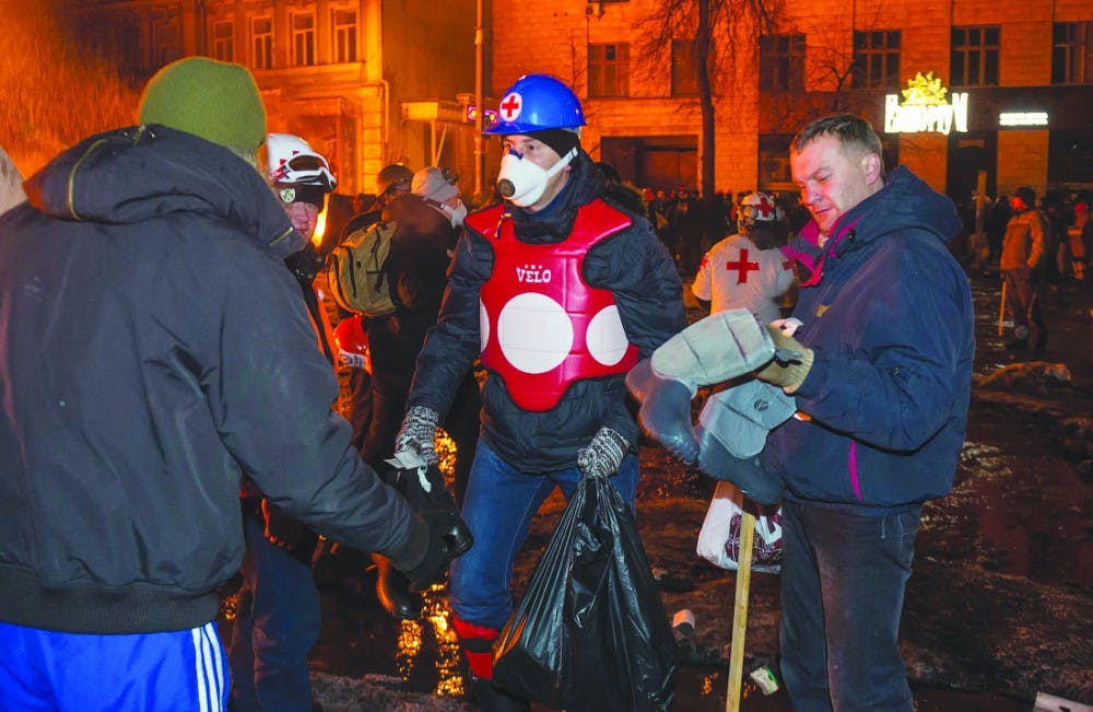 Volunteers hand out waterproof boots in the midst of the protest Jan. 22. PHOTO PROVIDED BY ILYA VARLAMOV