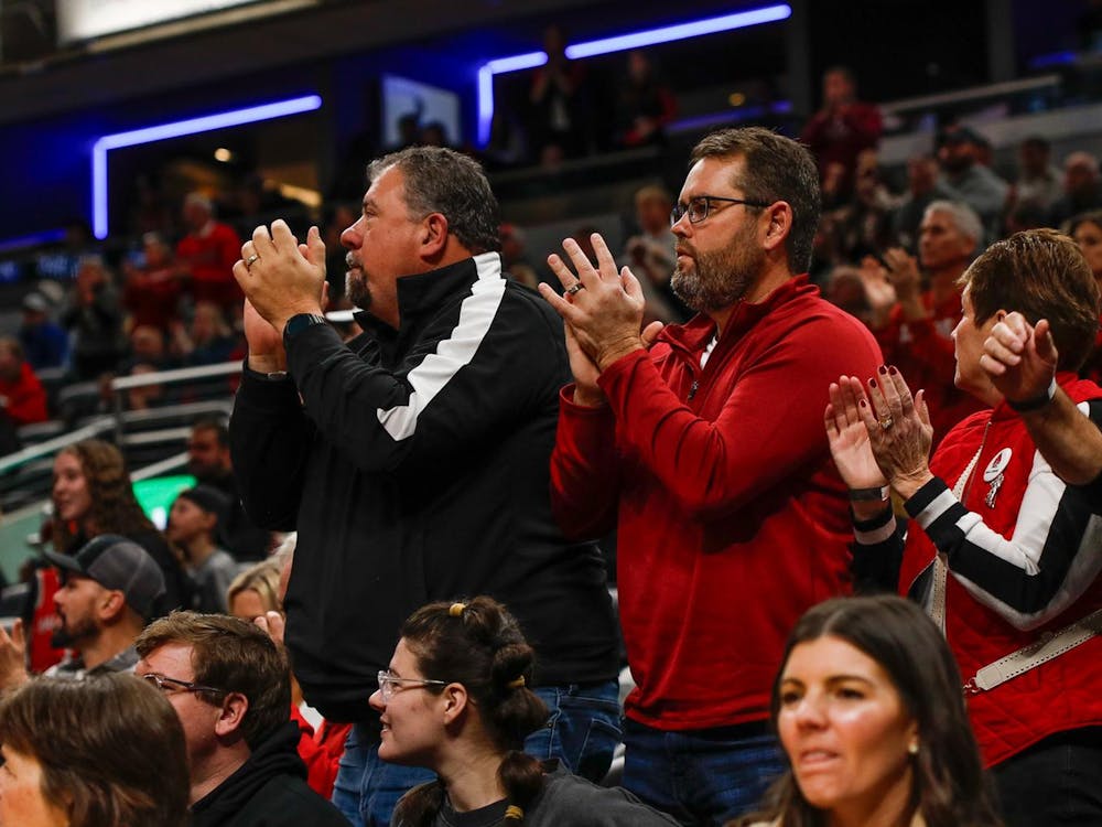 Ball State alumni sitting front row cheer after a Ball State point Dec. 16  against Indiana State at Gainbridge Fieldhouse. Andrew Berger, DN