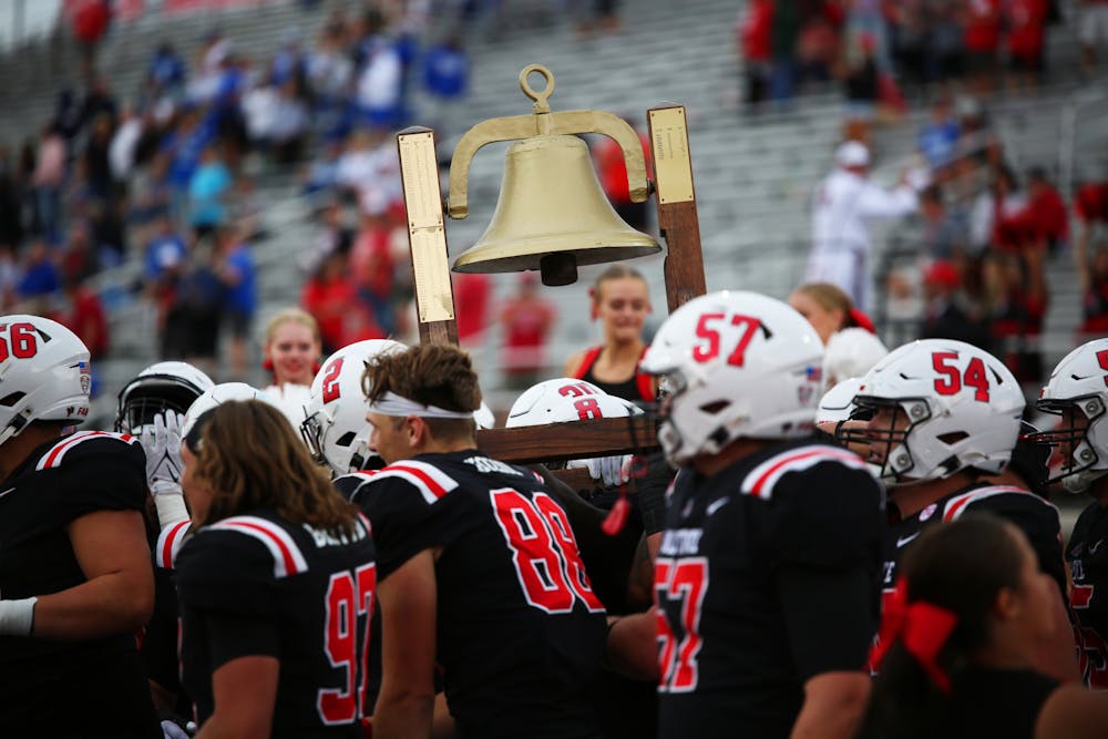 Ball State University football lifts the victory bell against Indiana State Sept. 16 at Scheumann Stadium. The cardinals won 45-7 against the sycamores. Mya Cataline, DN