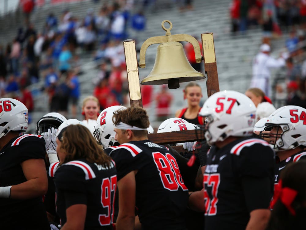 Ball State University football lifts the victory bell against Indiana State Sept. 16 at Scheumann Stadium. The cardinals won 45-7 against the sycamores. Mya Cataline, DN