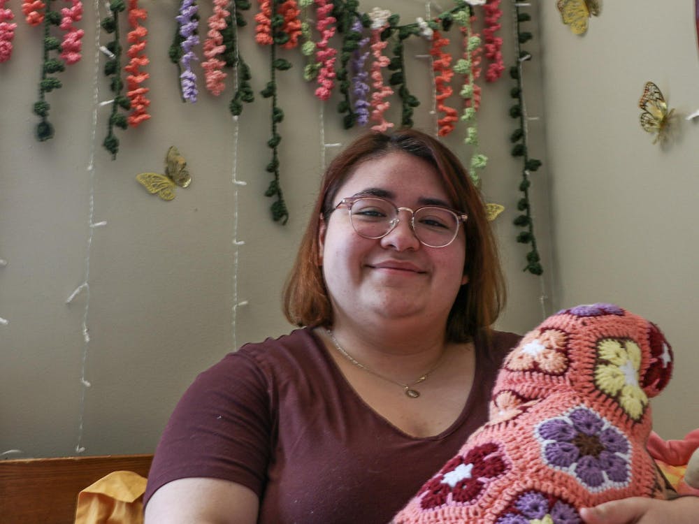Ball State sophomore Natalia Gonzalez sits on her bed while showing off a crocheted craft she made in her dorm on Feb. 15, 2024, in Muncie, Ind. Cristal Mariano-Vargas, Ball Bearings.