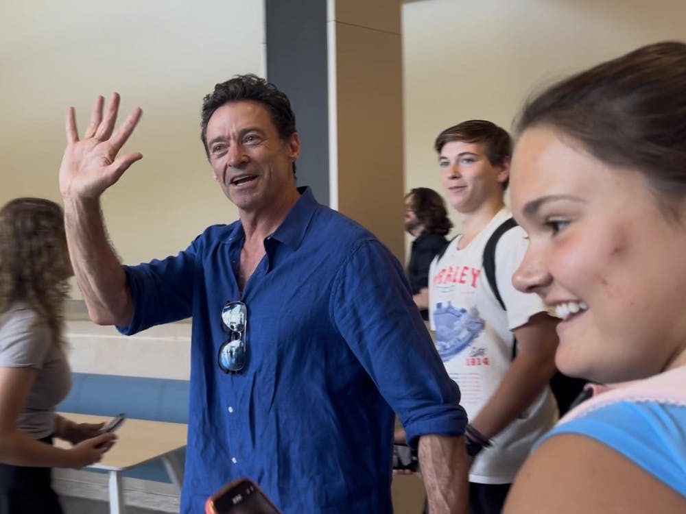 Hugh Jackman waving to students on Ball State campus.