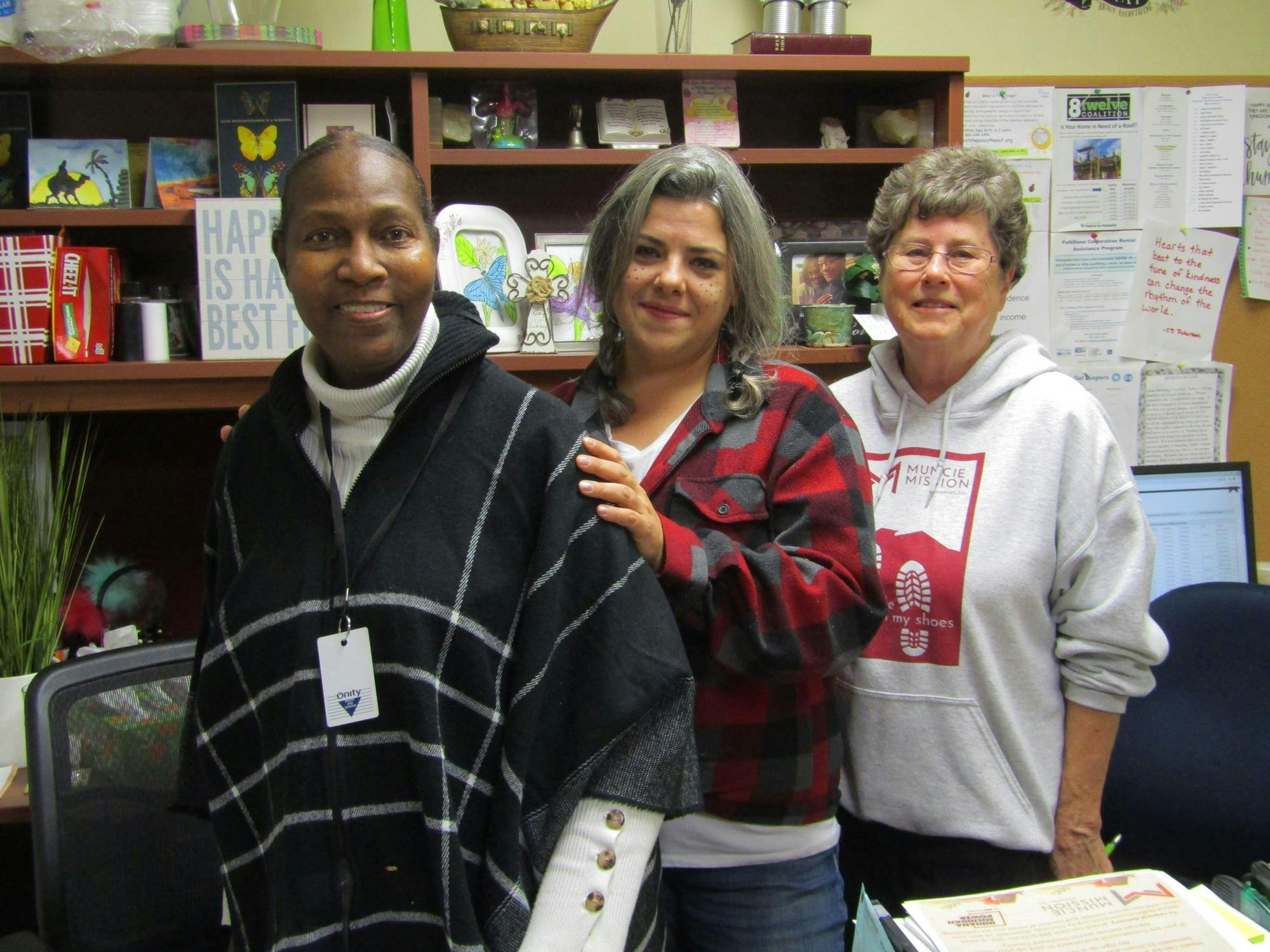 Lory Nunn (left), Kelly Vannetter (center) and Charlotte McKnight (right) pose for a photo Oct. 31 at Muncie Mission headquarters in Muncie, Indiana. The three women all credit volunteering to saving their lives in one way or another. Kyle Smedley, DN