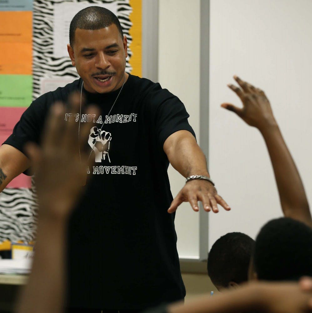 Kyle Early, founder of the Blue Program, leads a discussion about important life values with a group of Akron sixth graders at Crouse Community Learning Center on Thursday, Dec. 10, 2015, in Akron, Ohio. The new, district-wide mentoring program is a suicide prevention/emotional wealth program that helps them in the classroom and teaches them basketball skills for games they play on Saturdays. (Ed Suba Jr./Akron Beacon Journal/TNS)