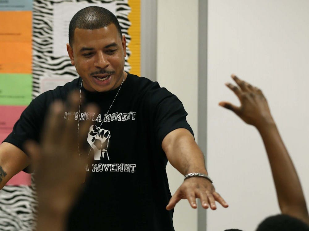 Kyle Early, founder of the Blue Program, leads a discussion about important life values with a group of Akron sixth graders at Crouse Community Learning Center on Thursday, Dec. 10, 2015, in Akron, Ohio. The new, district-wide mentoring program is a suicide prevention/emotional wealth program that helps them in the classroom and teaches them basketball skills for games they play on Saturdays. (Ed Suba Jr./Akron Beacon Journal/TNS)