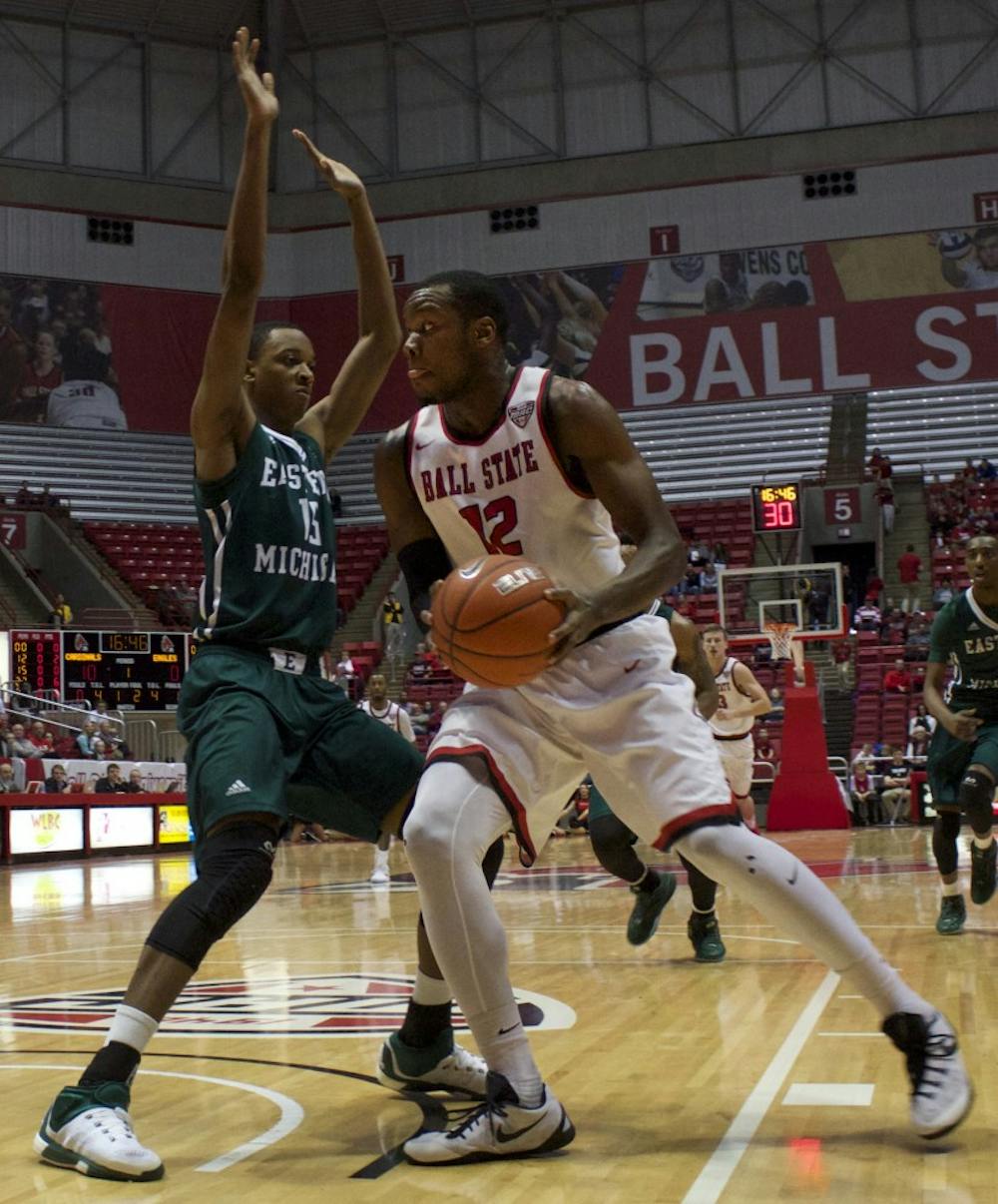 Senior forward Bo Calhoun for the Ball State Cardinals tries to move past Eastern Michigan’s defense in Worthen Arena on Feb. 27. DN PHOTO GRACE RAMEY