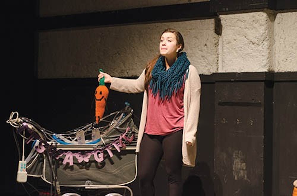 Monica Ramirez, a freshman musical theatre major, plays Colby in “Smudge.” Colby taunts her child with a carrot as she deals with the fact she is repulsed by her own baby. DN PHOTO COREY OHLENkAMP