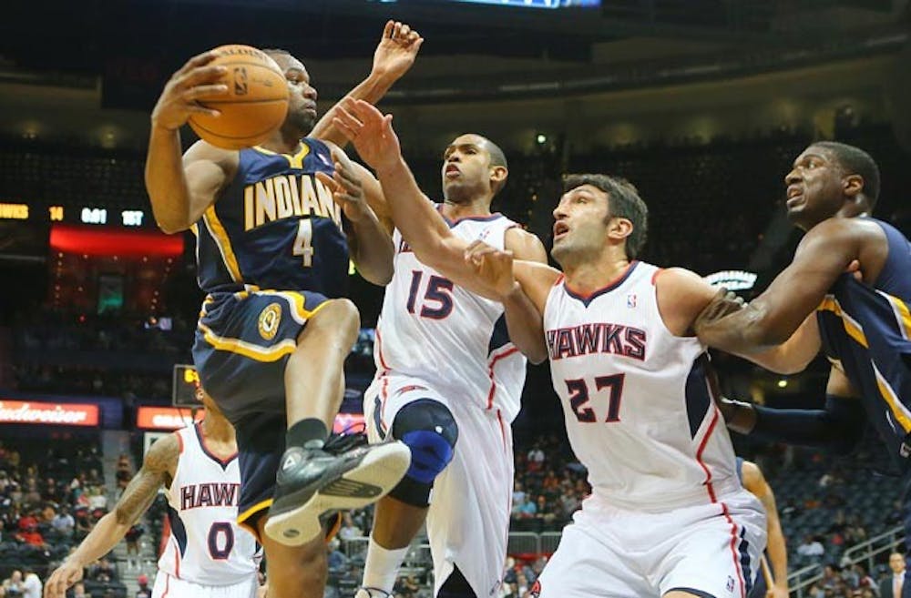 The Atlanta Hawks’ Al Horford and Zaza Pachulia force the Indiana Pacers’ Sam Young to pass it off under the basket during first-half action at Philips Arena in Atlanta on Nov. 7, 2012. The Pacers took on the Heat on Tuesday night, winning 87-77.  MCT PHOTO