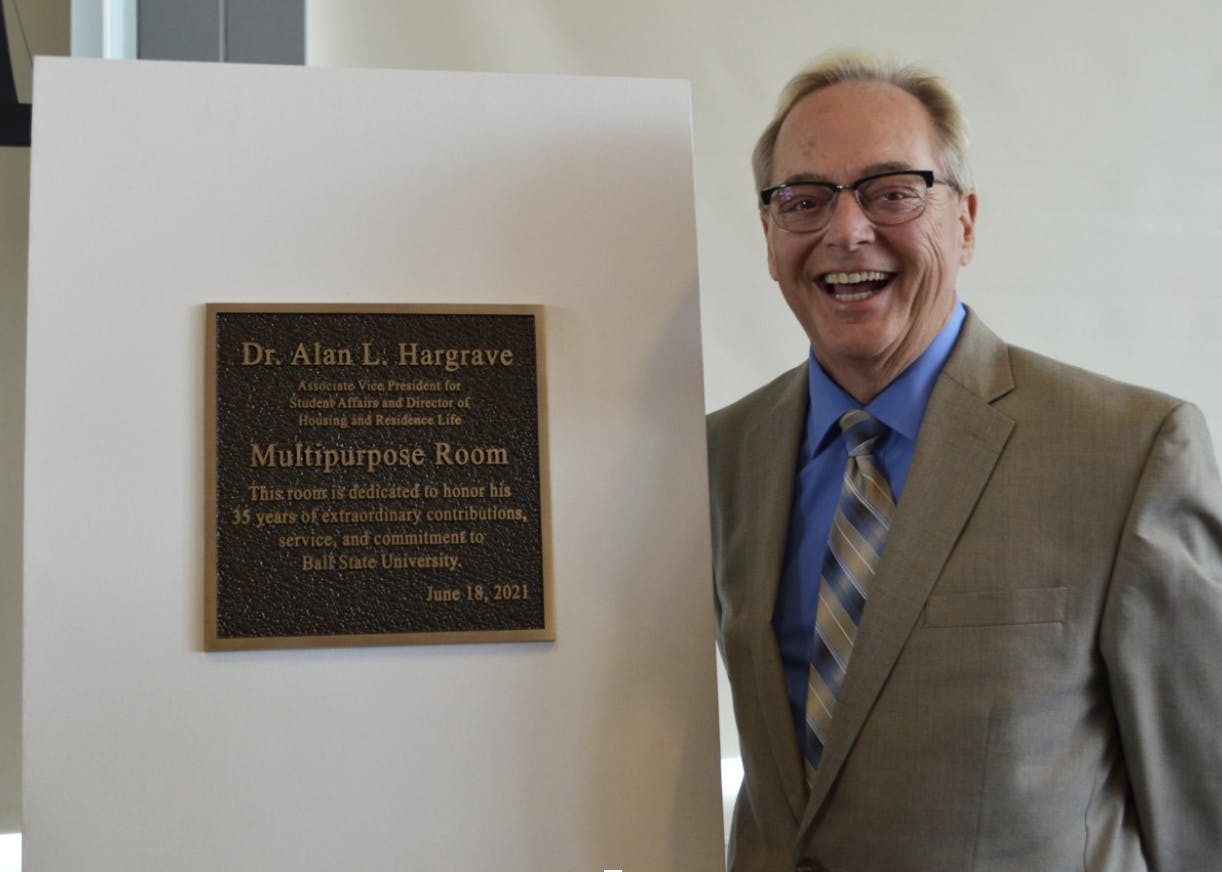 Alan L. Hargrave poses with the new Multipurpose Room sign on Friday, June 18, 2021.

