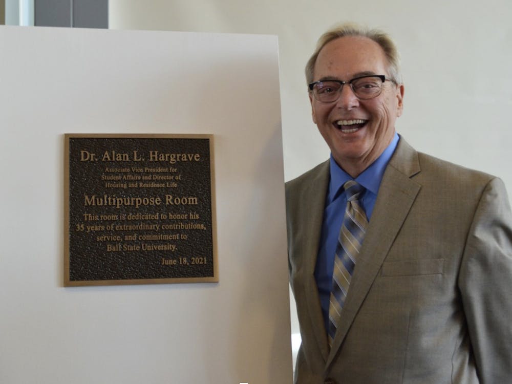 Alan L. Hargrave poses with the new Multipurpose Room sign on Friday, June 18, 2021.

