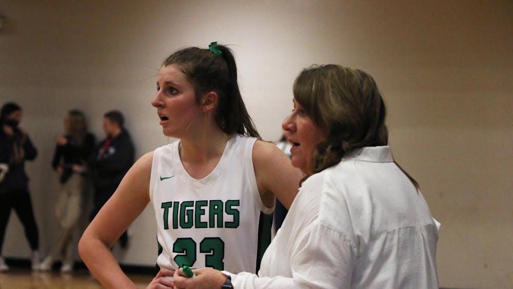 Yorktown senior Lily Sylvester and head coach Leigh Barga talk to an offical Jan. 13 after winning the Delaware County Tournament at Delta High School. Zach Carter, DN.