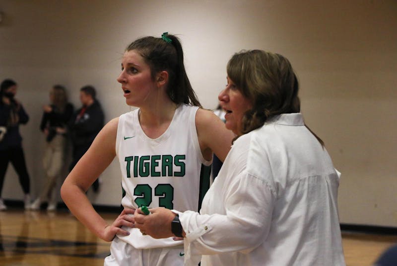 Yorktown senior Lily Sylvester and head coach Leigh Barga talk to an offical Jan. 13 after winning the Delaware County Tournament at Delta High School. Zach Carter, DN.