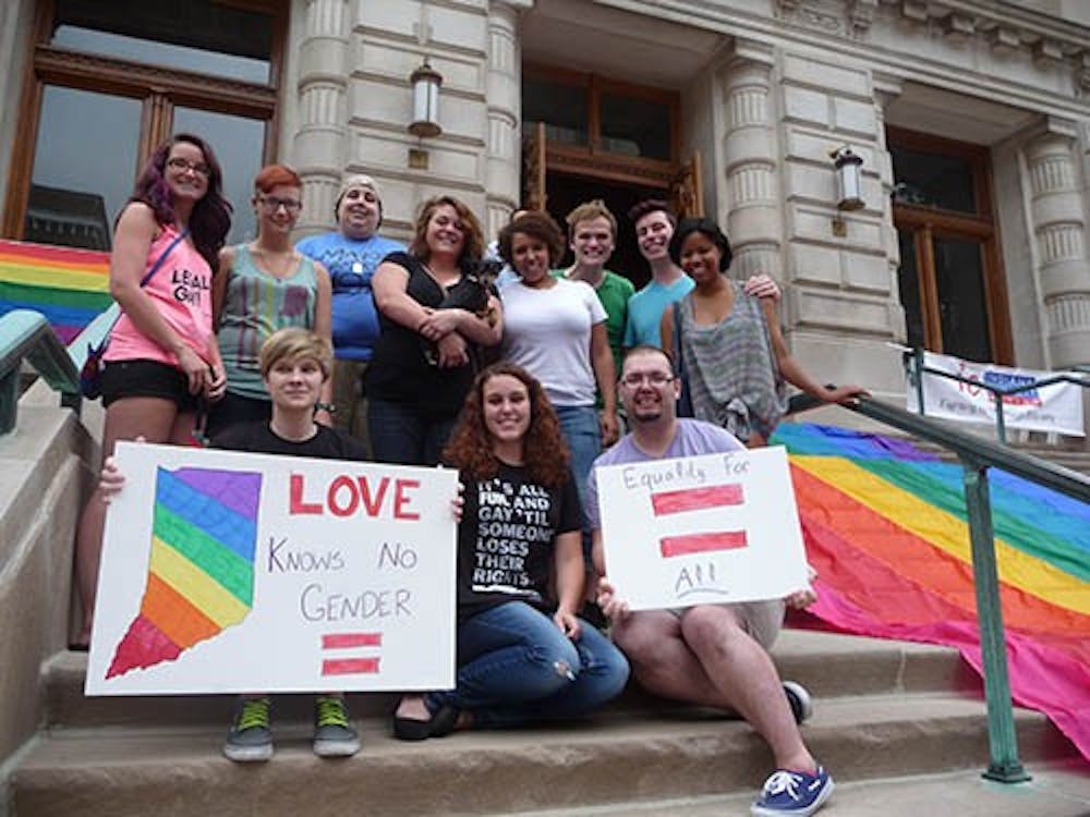 Spectrum, Ball State's GLBTSA Organization , gathers on the steps of the Indiana Statehouse. There were there to participate in a celebration of the recent surprise court decision. DN PHOTO DAKODA CRAWFORD 