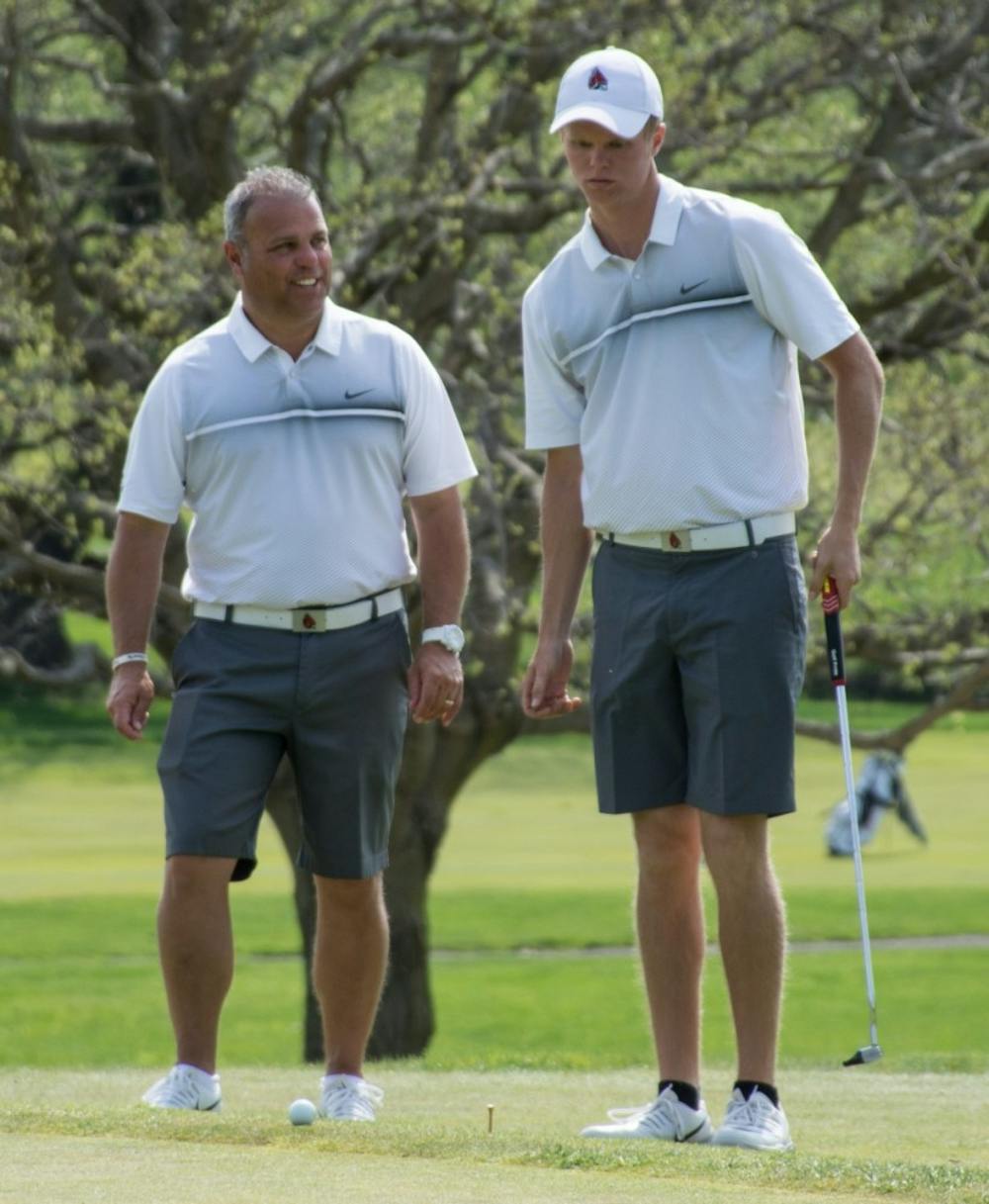 <p>Junior Michael VanDeventer talks with head coach Mike Fleck during the Earl Yestingsmeier Memorial Tournament at the Delaware Country Club on April 15. VanDeventer finished tied for first individually with a 2-under-par 208. Kaiti Sullivan, DN File</p>