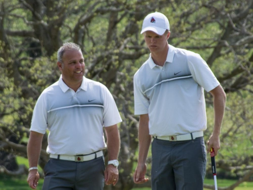 Junior Michael VanDeventer talks with head coach Mike Fleck during the Earl Yestingsmeier Memorial Tournament at the Delaware Country Club on April 15. VanDeventer finished tied for first individually with a 2-under-par 208. Kaiti Sullivan, DN File