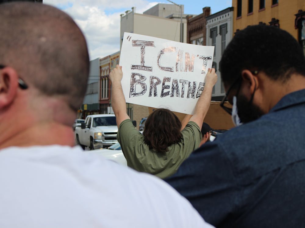 Duncan Bellard, a Hartford City, Indiana, resident, holds a sign saying, "I can't breathe," May 30, 2020, near the junction of Walnut and Main streets in downtown Muncie. Bellard came from his hometown, located 30 minutes away, for the protest. Bailey Cline, DN