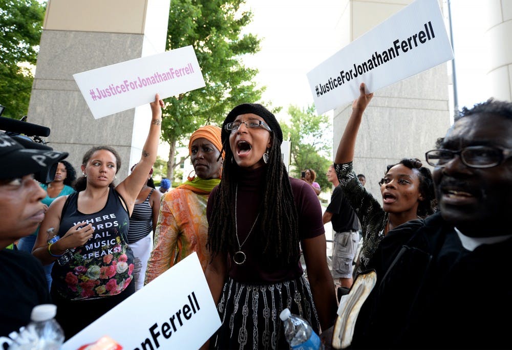 A young woman yells, "black lives matter," with other protesters at the Mecklenburg County Courthouse on Friday, August 21, 2015 protesting when after four days of deliberations, a mistrial was declared when the jury was unable to resolve a deadlock in the case of Randall "Wes" Kerrick in Charlotte, N.C. Kerrick, a Charlotte-Mecklenburg Police officer accused of killing an unarmed man, Jonathan Ferrell, in a struggle two years ago. (Jeff Siner/Charlotte Observer/TNS) 