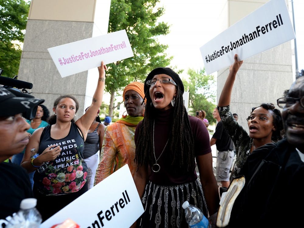 A young woman yells, "black lives matter," with other protesters at the Mecklenburg County Courthouse on Friday, August 21, 2015 protesting when after four days of deliberations, a mistrial was declared when the jury was unable to resolve a deadlock in the case of Randall "Wes" Kerrick in Charlotte, N.C. Kerrick, a Charlotte-Mecklenburg Police officer accused of killing an unarmed man, Jonathan Ferrell, in a struggle two years ago. (Jeff Siner/Charlotte Observer/TNS) 