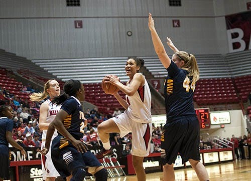 Freshman Nathalie Fontaine drives past two Toledo defenders during the home game against the Rockets on Feb. 10. Fontaine, a Swedish native, has had difficulty adjusting to the American style of play. DN FILE PHOTO BOBBY ELLIS
