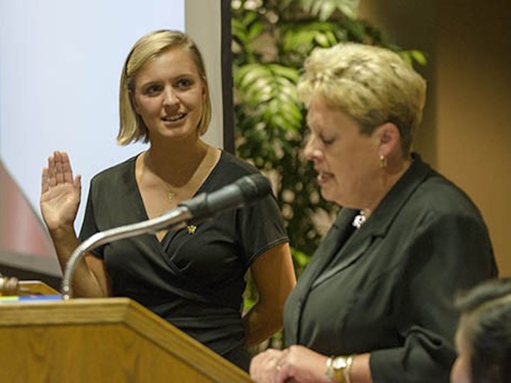 Chloe Anagnos, former vice president and now president of the Student Government Association, recites her oath along with faculty adviser Jennifer Jones-Halls on Sept. 11 in Cardinal Hall B. Anagnos is replacing former president Malachi Randolph, who resigned on Sept 4. DN PHOTO COREY OHLENKAMP