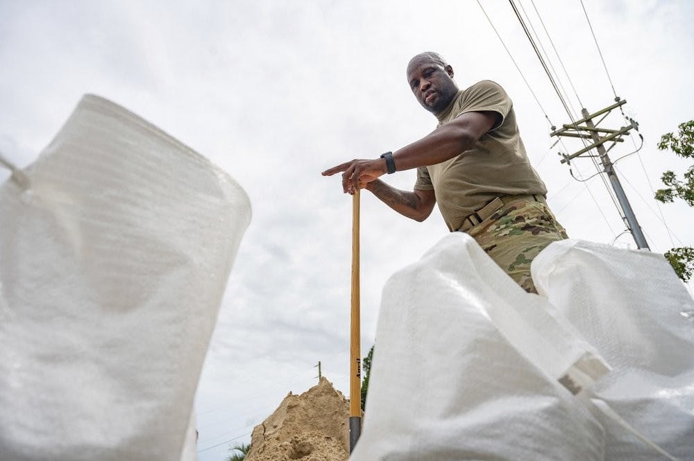 Anthony Woods, who serves in the Army, counts the sandbags that he will use help protect his home in Gulfport, Miss., as Hurricane Sally slowly approaches the coast on Monday, Sept. 14, 2020. (Lukas Flippo/The Sun Herald via AP)
