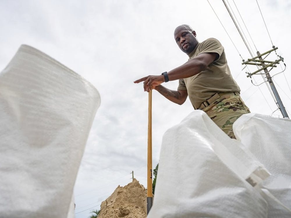 Anthony Woods, who serves in the Army, counts the sandbags that he will use help protect his home in Gulfport, Miss., as Hurricane Sally slowly approaches the coast on Monday, Sept. 14, 2020. (Lukas Flippo/The Sun Herald via AP)