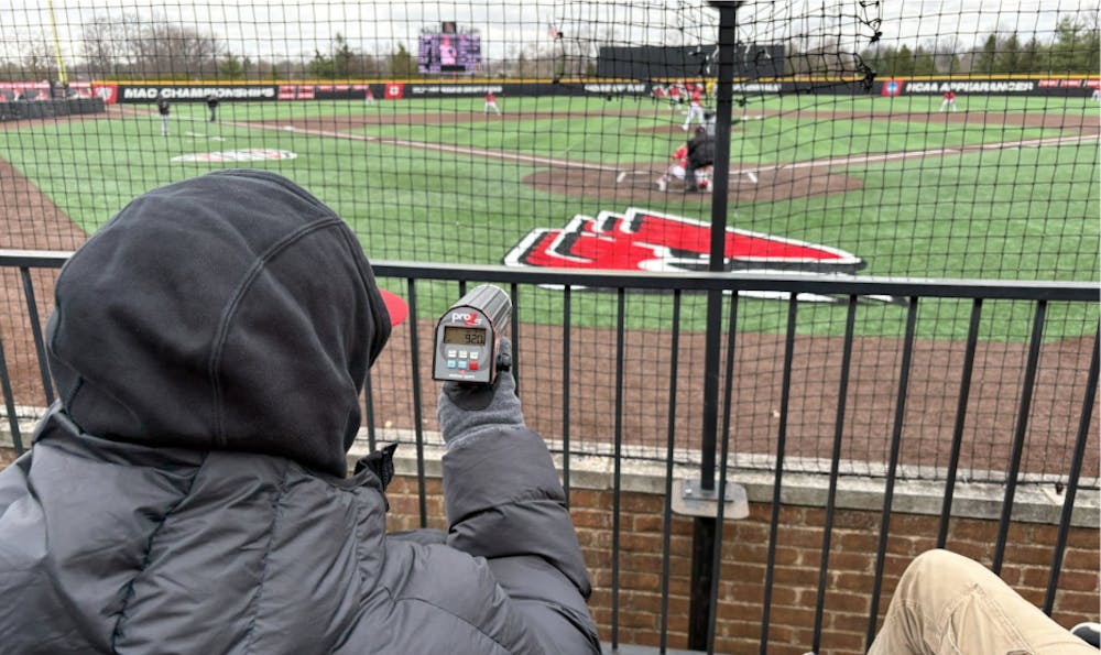 Student Manager, Palmer Phillips tracks the pitch velocity on the radar gun.