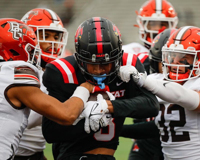 Ball State senior wide receiver Malcolm Gillie is tackled against Bowling Green on Nov. 23 at Schuemann Stadium. Gillie ran for 15 against the Falcons. Andrew Berger, DN 