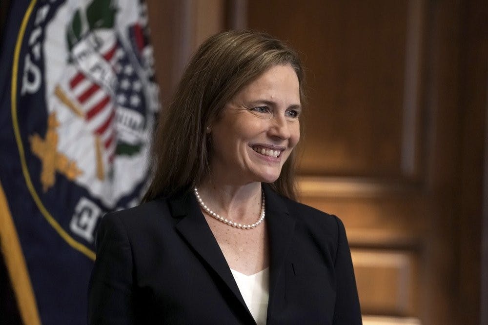 Supreme Court nominee Amy Coney Barrett, meets with Sen. Martha McSally, R-Ariz., Wednesday, Oct. 21, 2020, on Capitol Hill in Washington. Barrett was confirmed to the Supreme Court Oct. 26, 2020. (Greg Nash/Pool via AP)