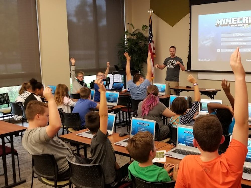 Ryan Hunter, co-founder of TechWise Academy, leads a Minecraft Party in which students get to learn about command blocks and play online in a safe environment. TechWise began regular coding classes for K-12 students in August. Brandon Coppernoll, Photo Provided