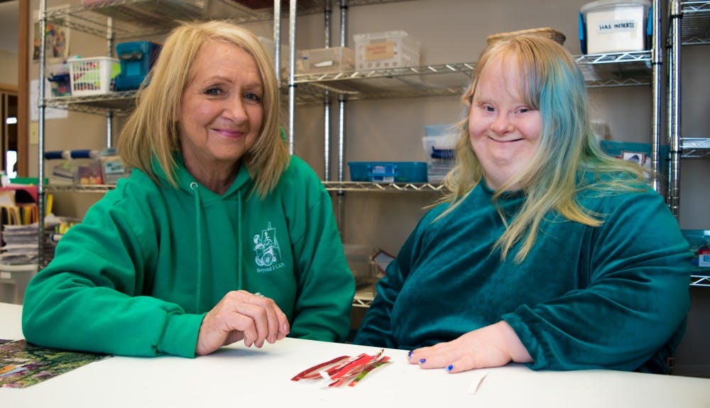 <p>Bernice Beaty, left, and her daughter Caitlyn, right, are apart of the community of "Beyond I Can". Caitlyn enjoys working on the strip machine where she can create shapes or words for holiday cards. <strong>Stephanie Amador, DN</strong></p>
