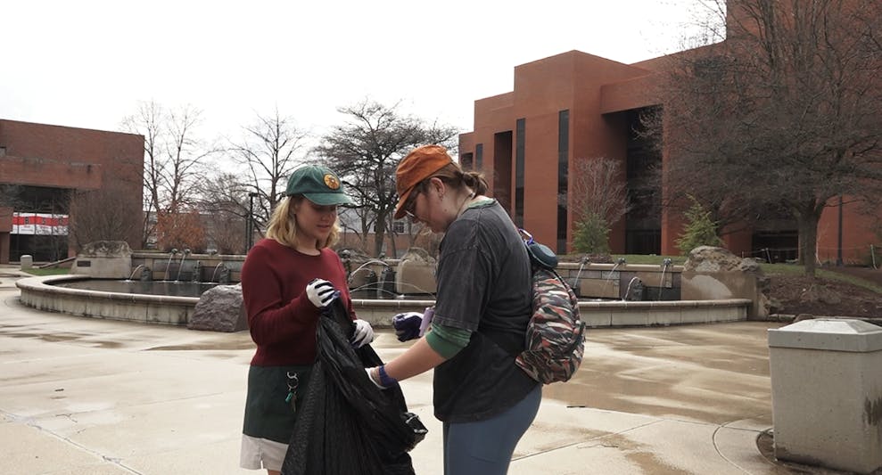 Kate McCaskill the president of the NREM club picking up trash with Tessa Williams the vice president of the NREM club. 