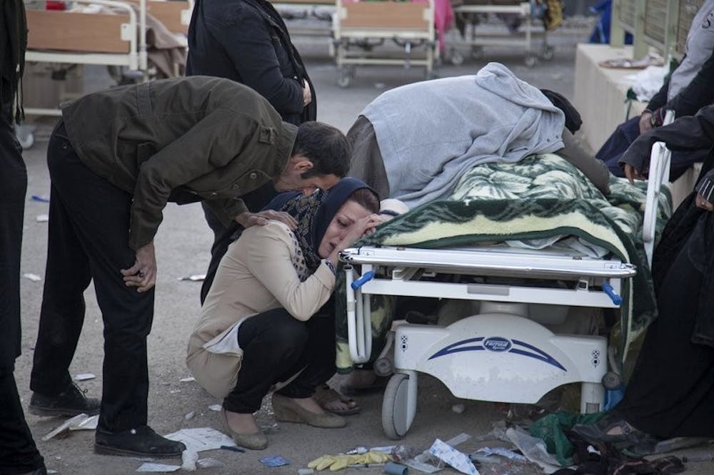 <p>In this photo provided by Tasnim News Agency, relatives weep over the body of an earthquake victim, Sarpol-e-Zahab western Iran, Monday, Nov. 13, 2017. Authorities reported that a 7.3 magnitude earthquake struck the Iraq-Iran border region on Monday and killed more than 300 people in both countries, sent people fleeing their homes into the night and was felt as far west as the Mediterranean cost. <strong>Farzad Menati, Tasnim News Agency via AP</strong></p>