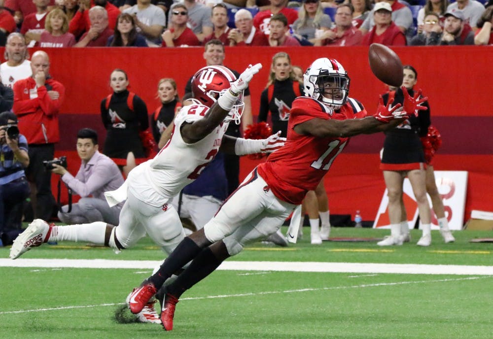 Ball State junior wide receiver Justin Hall lungs for the ball while being guarded by Indiana University sophomore defensive back Devon Matthews Saturday, Aug. 31, 2019 at Lucas Oil Stadium. The ball was not caught. Paige Grider, DN