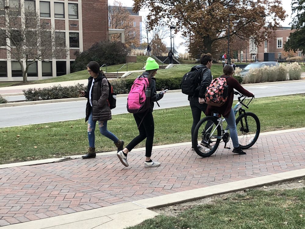 <p>A student rides a bike Nov. 20, 2019, on the sidewalk of McKinley Avenue on Ball State's campus. University Police Department has seen an increase in both the number of stolen bikes and an increase in bike registrations this academic year. <strong>Grace McCormick, DN</strong></p>