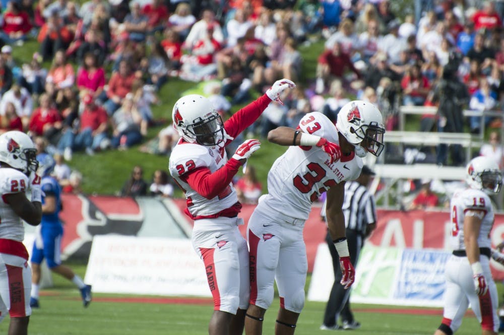 Senior Quintin Cooper and redshirt sophomore Tyree Holder celebrate after a play at the football game against Indiana State on Sept. 13 at Scheumann Stadium. DN PHOTO ALAINA JAYE HALSEY