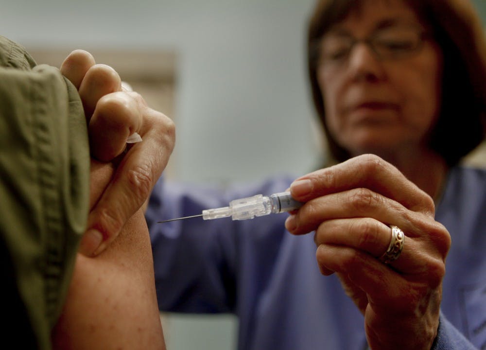 Downey Regional Medical Center RN Connie Meinke administers the flu vaccine to fellow employee Brian Virk on January 17, 2013. Like many hospitals across the U.S., the Downey, California, facility is preparing for the flu onslaught. The hospital is asking all of their employees to be vaccinated. (Mark Boster/Los Angeles Times/MCT)