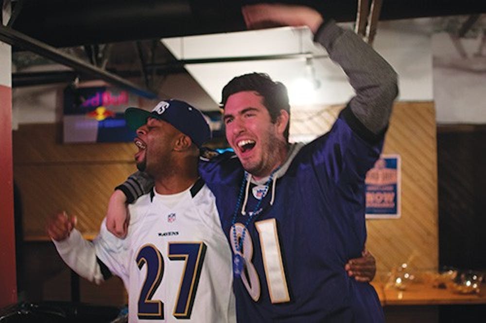 Fred Taylor, left, and Matt Isenogle celebrate after Baltimore Raven's Jacoby Jones returned a kick-off for a touchdown during Super Bowel 47. The Ravens defeated the San Francisco 49ers 34-29. DN PHOTO BOBBY ELLIS