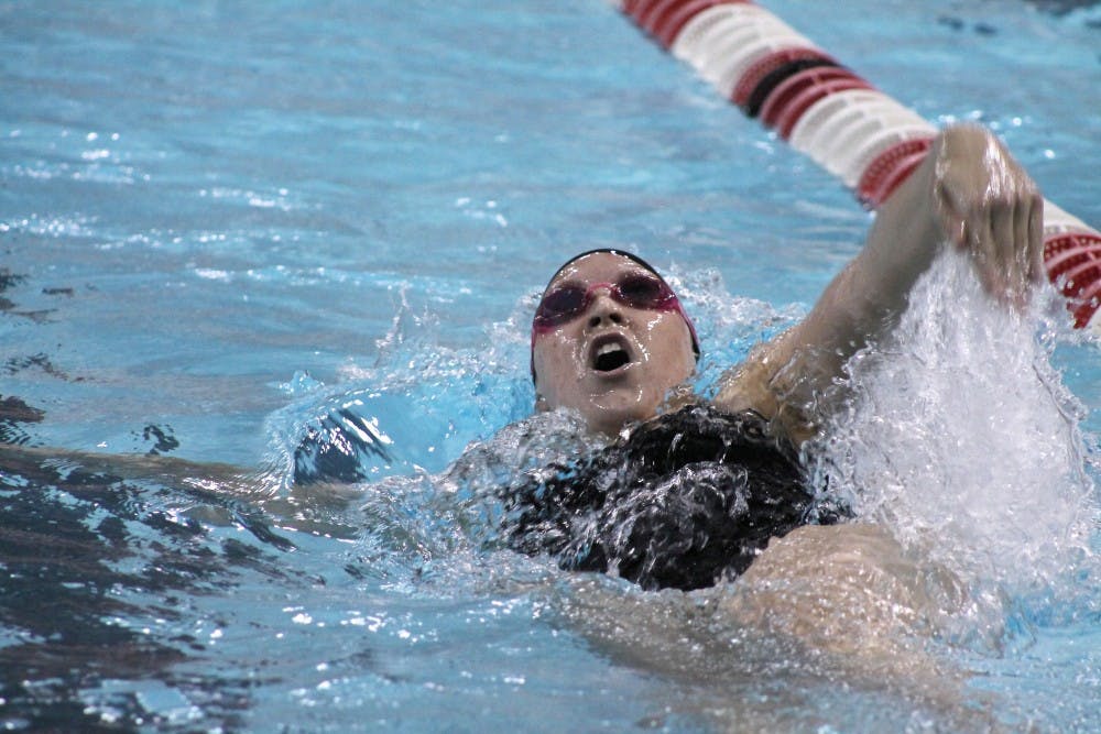 Freshman Courtney Mudd pushes through the last stretch of the 100-meter back swim during the Doug Coers Invitational on Nov. 23. DN PHOTO BRITTANY OVERSTREET