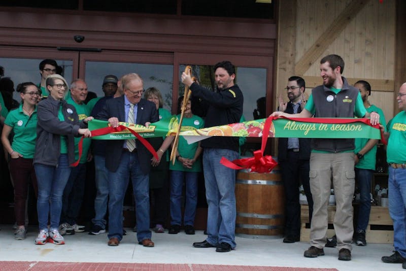 Mayor Tyler Dennis and Fresh Thyme employees cut the ribbon for their grand opening, Wednesday May 16 at the organic grocery store, Fresh Thyme. The store is located on West McGalliard road, next door to Chick-fil-A. Andrew Smith, DN