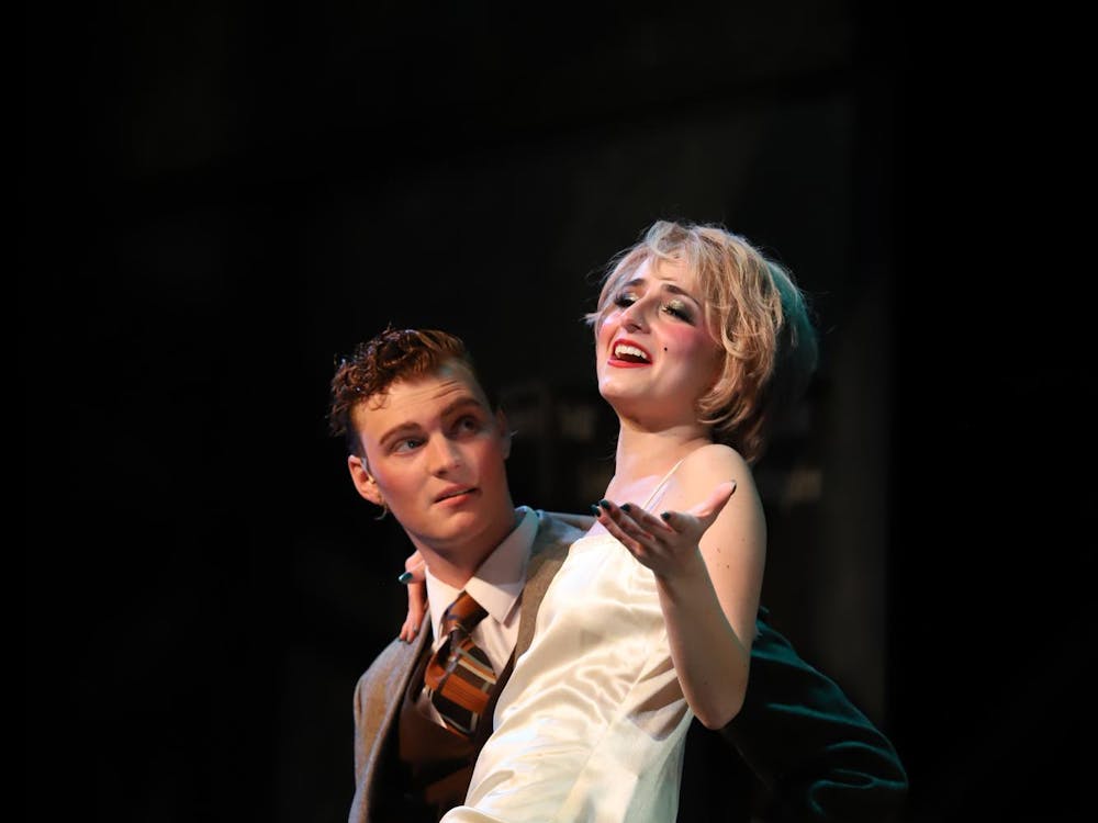 Riley McNerney (left), who plays Clifford Bradshaw and Emmie Ginsberg (right), who plays Sally Bowles, preform during Cabaret April 18 at University Theatre. Clifford is an American author who visits Berlin and meets Sally at the Kit Kat Klub. Olivia Gorund 