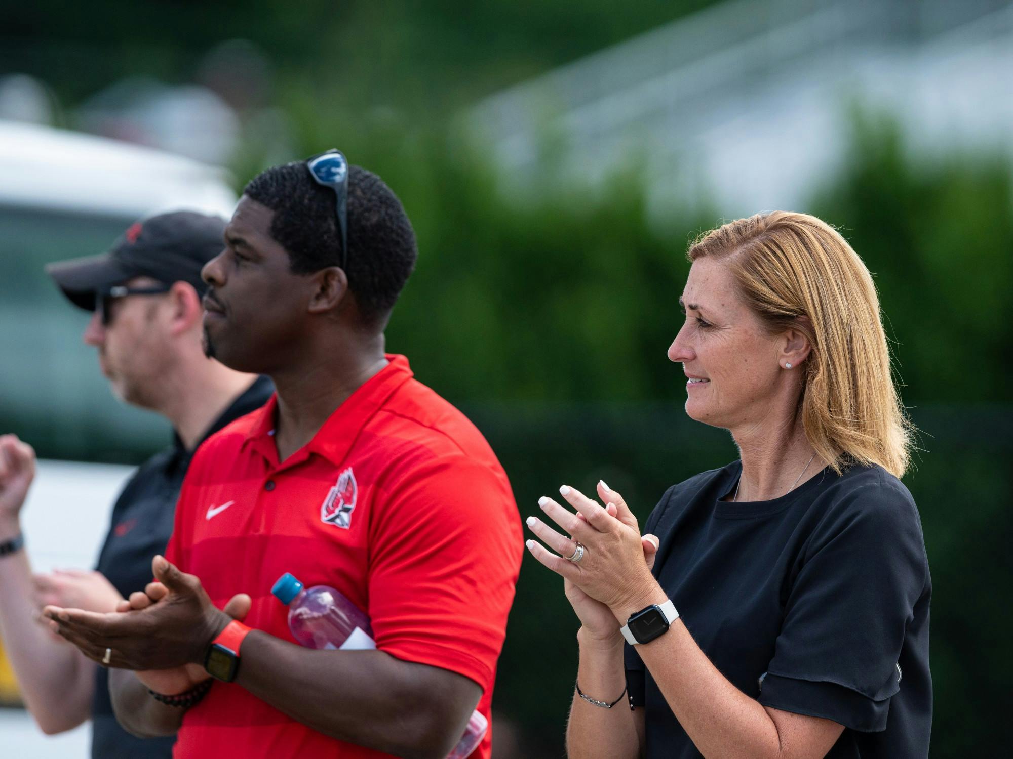Ball State Director of Athletics Beth Goetz (right), claps as the Ball State fight song is played after the field hockey match against Saint Francis University Aug. 26 at Briner Sports Complex. The Cardinals won 2-1 over Saint Francis in their season opener. Eli Houser, DN