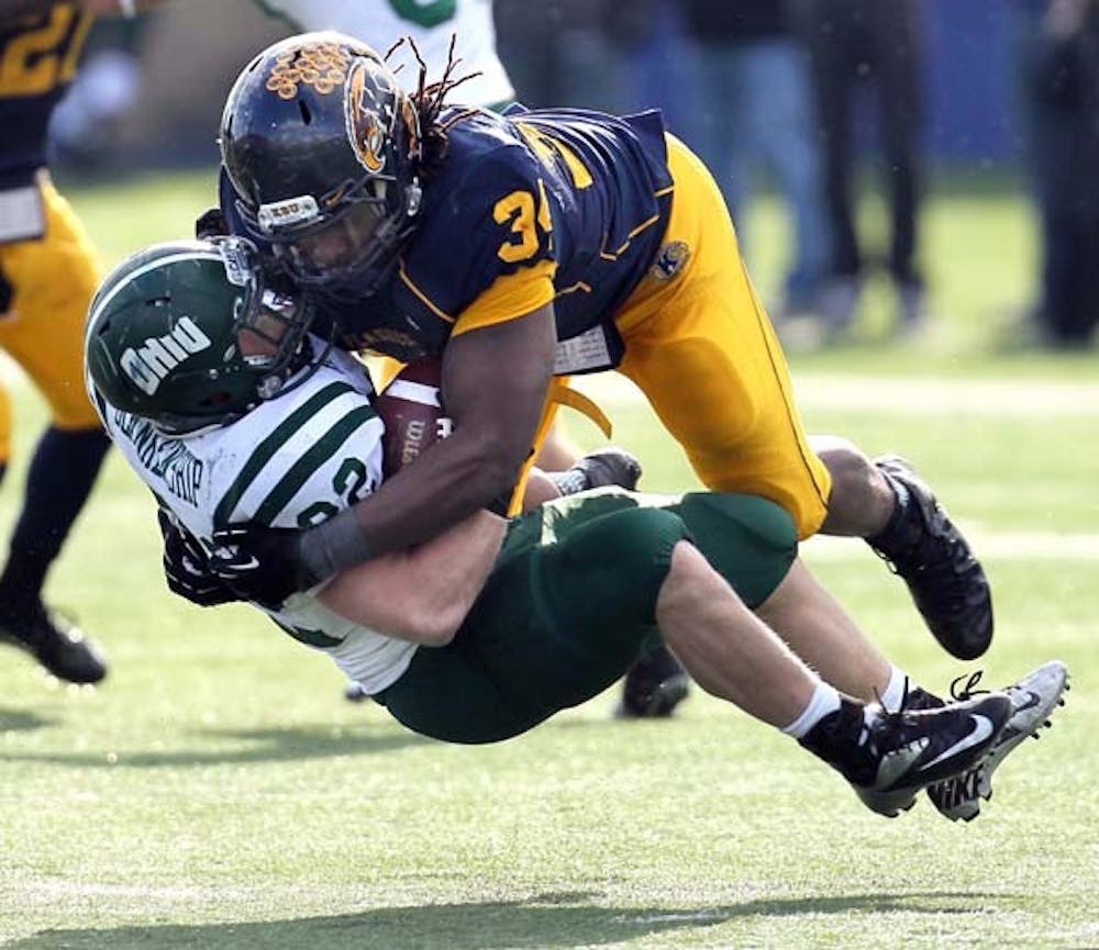 Kent State defensive end Richard Gray flattens Ohio University running back Beau Blankenship on a run in the fourth quarter at Dix Stadium on Nov. 23, in Kent, Ohio. If Kent State is able to beat Northern Illinois in the upcoming MAC championship, they might be able to play in a BCS bowl game. MCT PHOTO