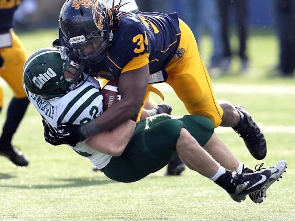Kent State defensive end Richard Gray flattens Ohio University running back Beau Blankenship on a run in the fourth quarter at Dix Stadium on Nov. 23, in Kent, Ohio. If Kent State is able to beat Northern Illinois in the upcoming MAC championship, they might be able to play in a BCS bowl game. MCT PHOTO