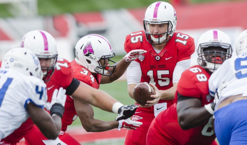 Freshman quarterback Riley Neal hands the ball off to freshman running back James Gilbert during the game against Georgia State on Oct. 17at Scheumann Stadium.  DN PHOTO BREANNA DAUGHERTY
