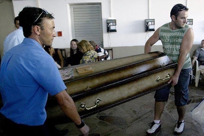 Two men carry a casket Sunday, January 27, 2013, of one of the victims from the &apos;Kiss&apos; nightclub fire in Santa Maria, Brazil. According to the latest reports, at least 232 people died and 48 were injured in the fire. (Neco Varella/EFE via Zuma Press/MCT)
